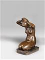 A bronze sculpture of a girl tying her hair - image-1