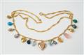 A gold, silver, enamel, gem-set charm necklace with egg- and heart-shaped pendants - image-1