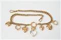 An Edwardian gold and rock crystal charm necklace with heart pendants - image-1