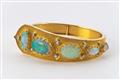 A gold and opal bangle with granulated decor - image-1