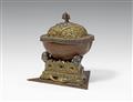 A Tibetan copper kapala with a brass lid and stand with silver details - image-2