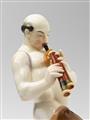 A Berlin KPM porcelain figure of an Arab man with bagpipes - image-2