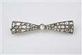 A 14k gold, silver, and diamond bow brooch - image-1