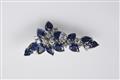 A small 18k white gold and sapphire brooch - image-1
