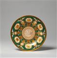 A Berlin KPM porcelain plate with green porphyry ground and trophies - image-1