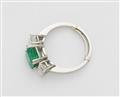 A platinum and emerald three stone ring - image-2