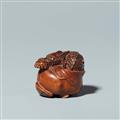A wood netsuke of a dragon in a fruit. 19th century - image-1
