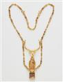 A 22k gold necklace with an Egyptian amulet - image-1