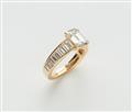 An 18k gold Cartier ring with an emerald-cut diamond solitaire - image-2