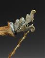 A brass bow with animal fur - image-2