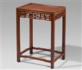 A tall hardwood side table - image-1