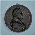 A round cast iron plaque with a portrait of Martin Luther - image-2