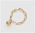 An 18k gold bracelet with a walnut charm - image-1