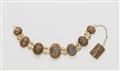 A 21k gold bracelet with scarab amulets - image-1