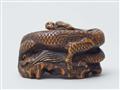 A boxwood netsuke of a dragon on a rock. First half 19th century - image-3