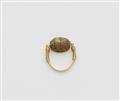 An 18k gold twisting ring with an ancient Egyptian scarab amulet - image-1