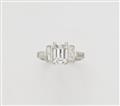 A platinum diamond ring with an emerald-cut diamond solitaire - image-1