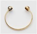 An Austrian 18k gold bangle with two large sapphire cabochons. - image-2