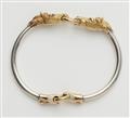 A silver and 18k gold horse head bangle. - image-2