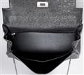 A black ostrich leather Hermès Kelly bag 28 with silver palladium hardware. - image-8