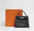 A black ostrich leather Hermès Kelly bag 28 with silver palladium hardware. - image-1