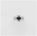 An 18k white gold diamond and sapphire cluster ring. - image-1