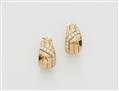 A pair of 18k "Fami" Cartier diamond clip earrings. - image-1