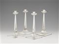 A set of four Arts & Crafts silver candlesticks - image-1