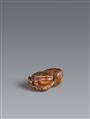 An Ise-Yamada boxwood netsuke of a toad next to a rock. 19th century - image-1