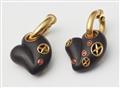 A pair of 18kt gold hoop earrings with ruby set carved ebony heart pendants. - image-2