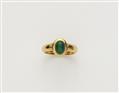 A German 18/21k gold and emerald cabochon ring with swiveling ring head. - image-1