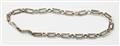A silver 14k gold and diamond chain necklace convertable into two bracelets. - image-3