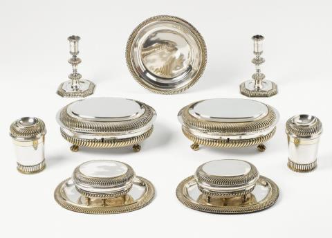 Christian Winter und Georg Friebel - An Augsburg silver partially gilt travel service. Comprising two boxes with presentoires, two locking boxes (one with key), a pair of candlesticks, a pair of lidded beakers and a plate. Marks of Christian Winter and Georg Friebel, 1699 - 1703.