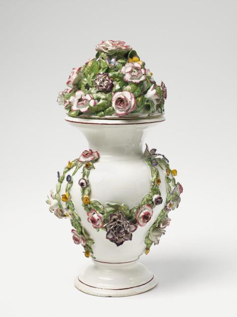  Strasbourg - A faience potpourri vase with overglaze decor and sculpted flowers and leaves