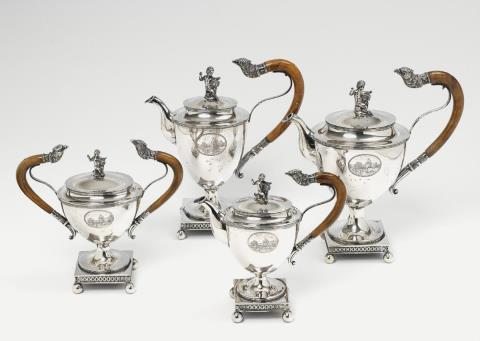  Schleissner & Söhne - An empire style Hanau silver partially gilt service. Comprising coffeepot, teapot, sugar box and milk jug. Marks of Schleissner & Söhne, ca. 1900.