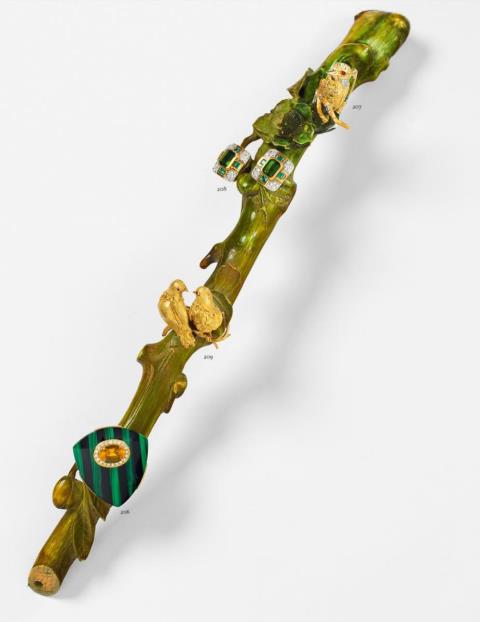 A yellow sapphire, onyx and malachite brooch formed as a shield.