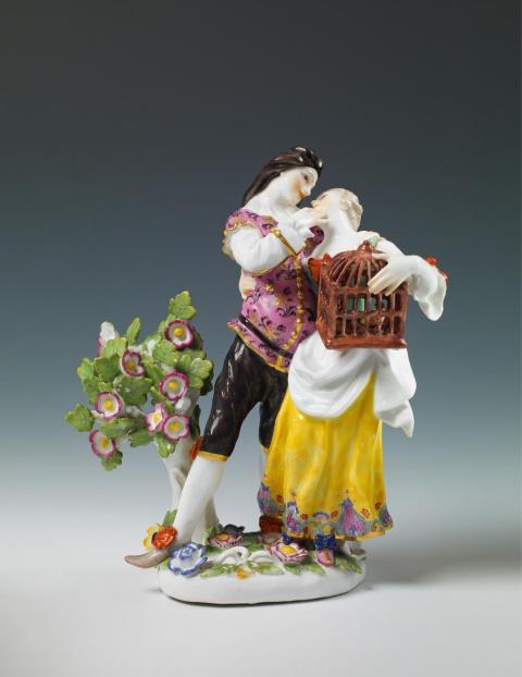 A rare Meissen group "La cage", depicting Scaramouche and Columbine with a birdcage beside a flowering shrub.