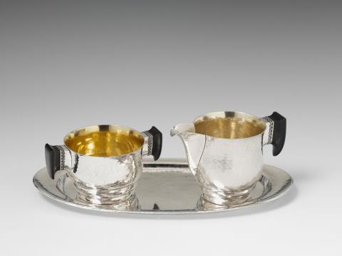 Hans Markl - A Berlin silver interior gilt cream set. Comprising sugar bowl, milk jug and tray with ebony handles. In the original case. Marks of Hans Markl (1935 - 71).