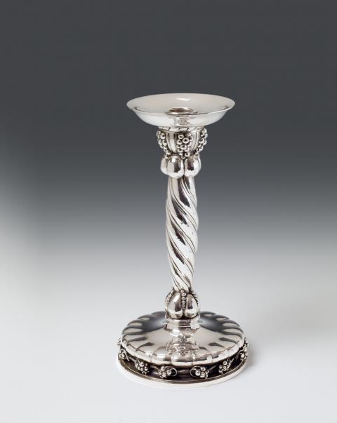 A large Copenhagen silver candlestick, no. 264. "Grape" pattern, with a dedication to the underside, dated 1960. Marks of Georg Jensen, designed in 1926, made in 1960.