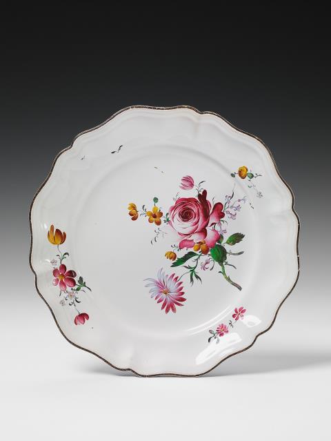 Joseph Hannong - A scalopped Strasbourg faience plate with floral overglaze decor.
