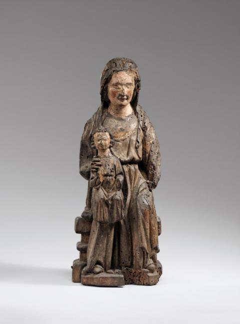 Alsace - A probably Alsatian carved wooden figure of the Virgin enthroned, first half 13th century.