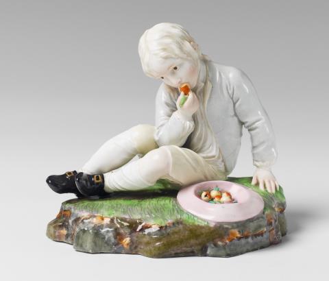 A Höchst porcelain figure of a boy eating a pear.