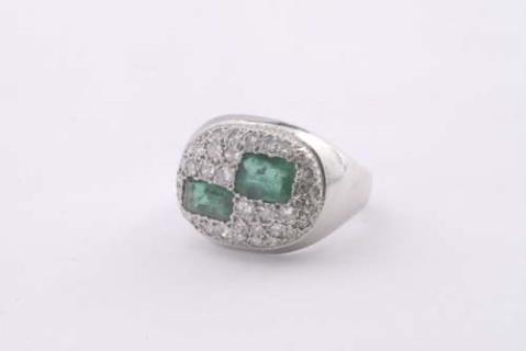 An 18k gold, diamond and emerald ring.
