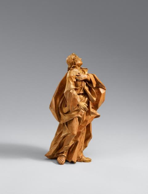 Johann Benedikt Witz - A carved limewood figure of the mourning Saint John from a crucifixion group.