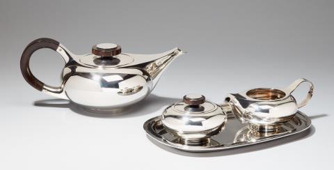  Robbe & Berking - A Bremen silver tea service. Comprising teapot, milk jug, sugar box and small tray; the handles of grenadilla wood. Designed by Max Lorenzen, 1960s.