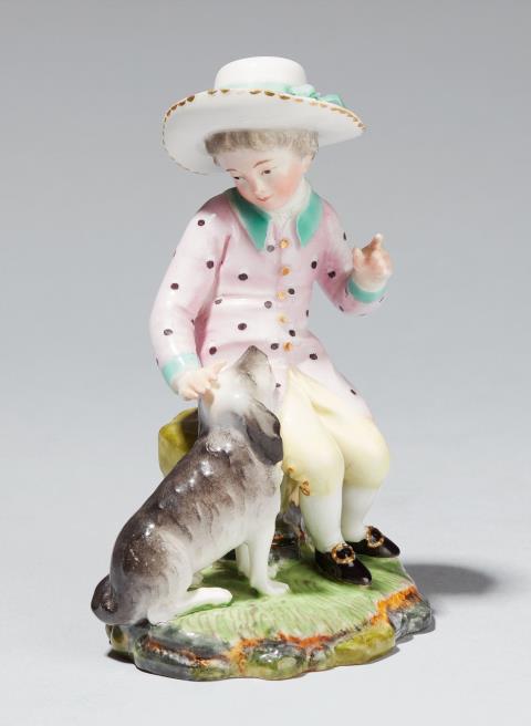 A Höchst porcelain figure of a boy with a dog