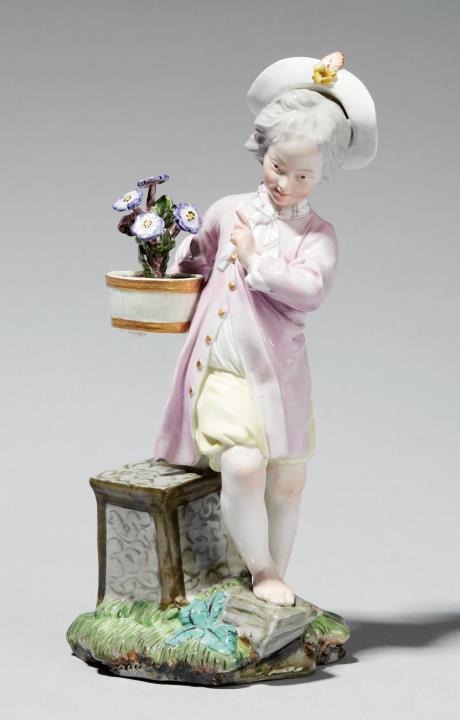 A Höchst porcelain figure of a boy with a shrub