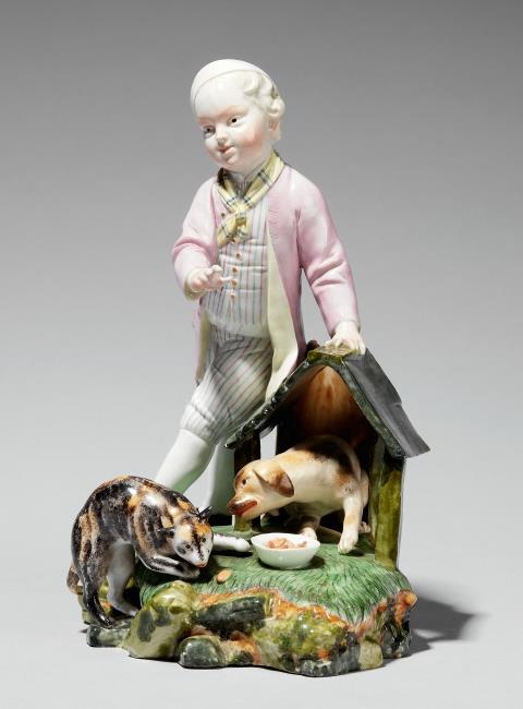 A Höchst porcelain model of a boy by a dog kennel