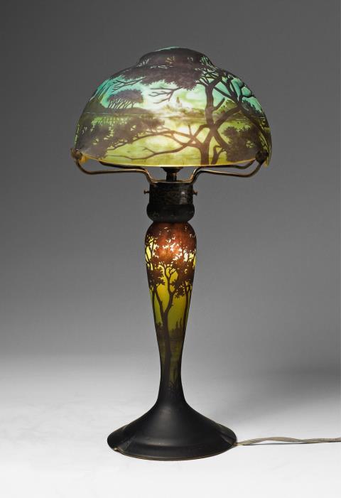 A Daum Frères glass table lamp with etched Rhine river landscape decor