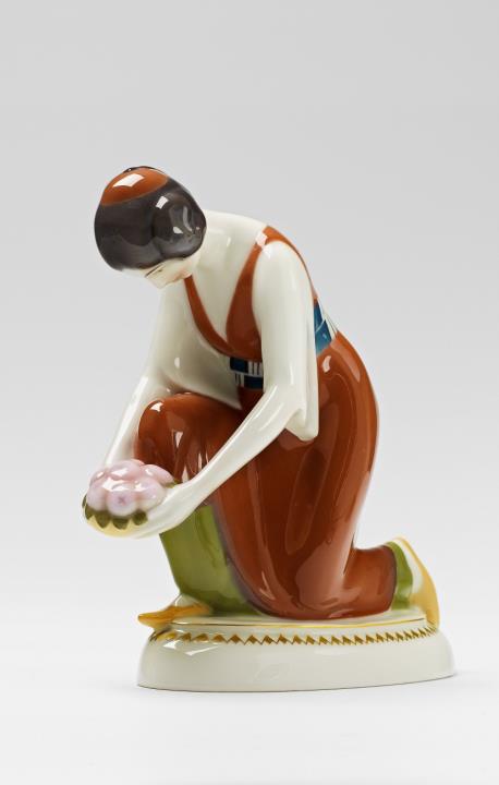 Adolph Amberg - A Berlin KPM porcelain figure of a kneeling Turkish lady with a bowl of fruit